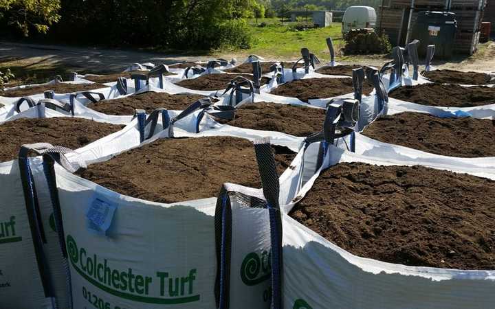 Bags of topsoil waiting to be delivered